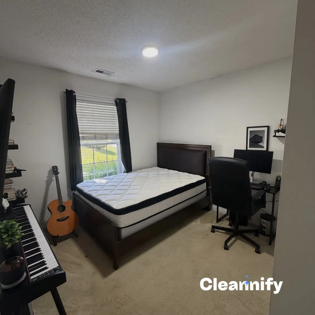 After residential bedroom cleaning in Charlotte with a made bed and tidy room