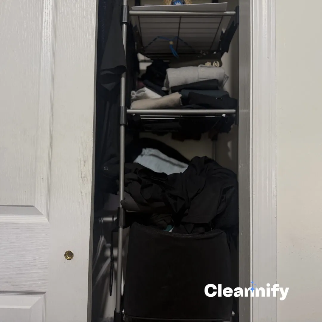 Before closet organization in Charlotte showing clothes piled in a closet